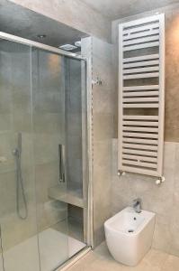 a bathroom with a shower and a sink and a toilet at B&B Cava Rossa in Monsummano
