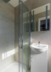 a bathroom with a glass shower and a sink at Burrows Lodge in Waterford