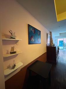 a room with shelves on a wall with a table at Curpi de Ma in Bonassola