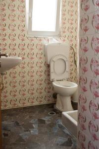 a bathroom with a toilet and a sink at MASTIHA SeaSide Emporios Apartments in Emporeios