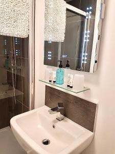 a bathroom with a sink and a mirror at Palma Guest House in St Ives