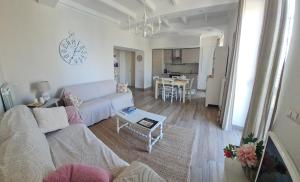 a living room with a white couch and a table at La casetta del nonno in Capodimonte