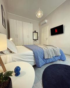 a bedroom with a bed and a tv on the wall at 50 Papiniano apartment in Milan