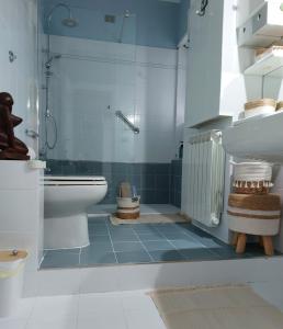 a blue and white bathroom with a toilet and a sink at Appartamento CasaZeta luminoso e centralissimo in Latina +43 photos