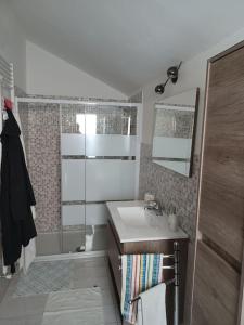 a bathroom with a sink and a shower at La corte in Vezzo