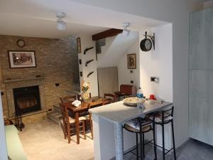 a kitchen and a living room with a fireplace at La corte in Vezzo