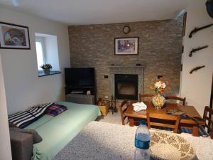 a living room with a bed and a fireplace at La corte in Vezzo