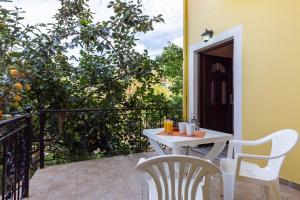 a white table and chairs on a balcony at Eros appartments in Kalamitsi