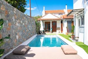 a swimming pool in the backyard of a house at Del Sol Suites in Skiathos