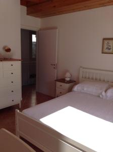 a bedroom with a bed and a dresser at La Casa di Miro in Nesso