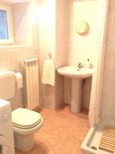 a bathroom with a toilet and a sink at La Casa di Miro in Nesso