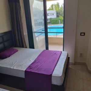 a bedroom with a bed with a view of a pool at Criss Resort-Naama Bay in Sharm El Sheikh