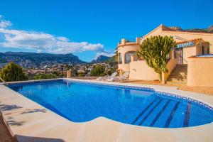 a swimming pool in front of a villa at Villa Markus - Plusholidays in Calpe