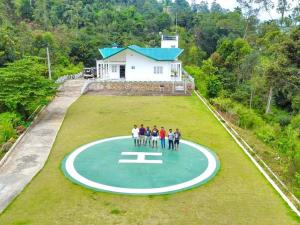 a group of people standing on a circle in front of a house at Mount edge riverside hotel in Bandarawela in Bandarawela