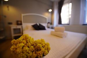 a pile of yellow flowers sitting on top of a bed at ACHİLLES BOZCAADA in Bozcaada