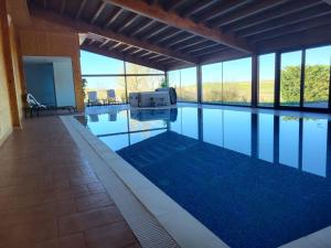 a swimming pool with a grill in a house at La Parada del Cid in Espinosa de Cervera