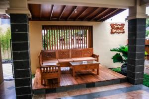 a porch with a bench and a table at Griya Wijilan Syariah in Yogyakarta