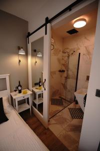 a bathroom with a shower and a bed and a sink at ACHİLLES BOZCAADA in Bozcaada