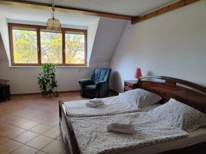 1 dormitorio con 2 camas, silla y ventana en Ferienwohnung Hohenroda, en Hohenroda