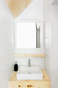 a bathroom with a white sink and a mirror at Gather Greene in Coxsackie