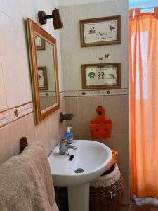 a bathroom with a sink and a mirror at ApartBeach Wyliana in Candelaria