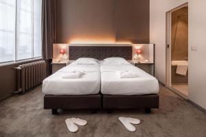 Voodi või voodid majutusasutuse Hotel Navarra Brugge toas