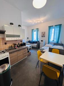 a kitchen and living room with a bed and a table at Apartmá Luxura in Děčín