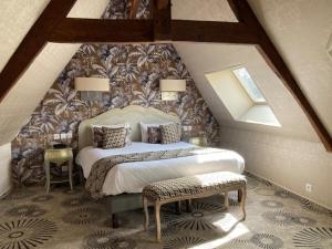 a bedroom with a large bed in a attic at Hotel Le Lion D'Or et Restaurant La Table Du Lion in Bayeux