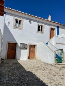 a white building with two doors and a staircase at Paço Marmòris Field in Sintra
