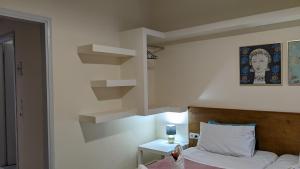 a room with a bed and a book shelf at Pension Irene in Sougia