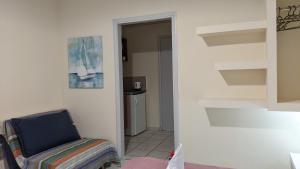 a living room with a chair and a hallway at Pension Irene in Sougia
