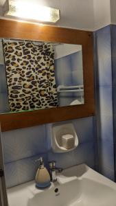 a bathroom with a sink and a mirror at Pension Irene in Sougia