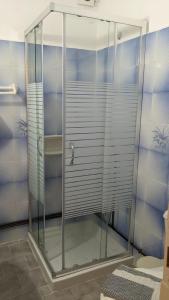 a shower with a glass door in a bathroom at Pension Irene in Sougia