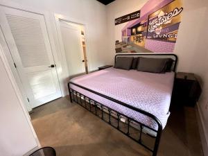 a bed in a room with a sign on the wall at BNA Carpet Condo - 4 miles to DT in Nashville