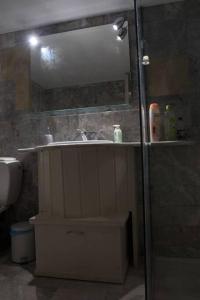 La salle de bains est pourvue d'un lavabo et d'un miroir. dans l'établissement Natural House with Sea View & Garden, à Héraklion