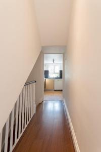 an empty hallway with a staircase in a house at Beautiful Home in Camden with Garden in London