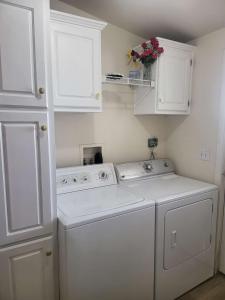 a white laundry room with a washer and dryer at Sun Angel House #1 Pahrump in Pahrump