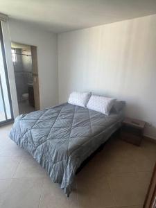 a bedroom with a bed with two pillows on it at Fresco, cómodo y Amplio! in Neiva
