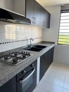 a kitchen with a stove and a sink at Fresco, cómodo y Amplio! in Neiva