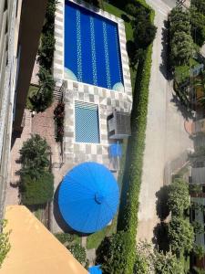 an overhead view of a blue umbrella next to a swimming pool at Fresco, cómodo y Amplio! in Neiva