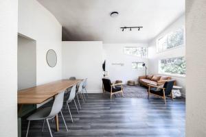 a living room with a table and chairs and a couch at Modern Boho - Hot Tub - 9 min to Downtown in Flagstaff