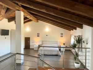 a bedroom with a bed in a room with wooden ceilings at Il Girasole Apartments - Langhe in Treiso