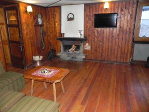 a living room with a couch and a fireplace at Hotel Nuovo Pecetto in Macugnaga