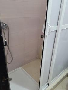 a shower with a glass door in a bathroom at Elegant 2-bedroom Tangiers City Appartment with Beautiful Terrace in Tangier
