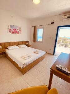 a bedroom with a bed and a table and a window at ASPAT HOTEL BODRUM - Beach&Restaurant in Bodrum City +48 photos