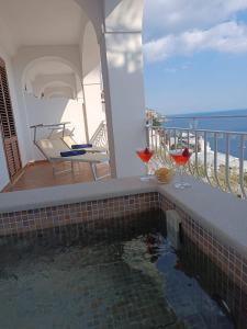 a swimming pool on the balcony of a house at Hotel Il Gabbiano in Positano