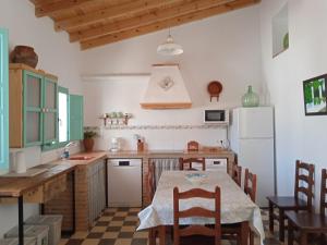 kuchnia ze stołem i lodówką w obiekcie Casa de las Bóvedas w mieście Rosal de la Frontera
