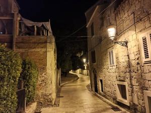 an alley at night in an old town at The center of Split, renovated stone house in Split