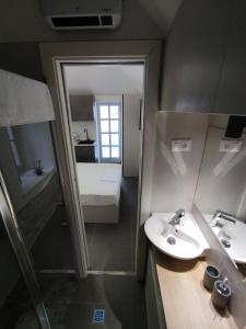 a small bathroom with a sink and a shower at The center of Split, renovated stone house in Split