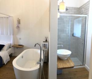 a bathroom with a bath tub and a shower at Honeybee Cottage, Waddington in Waddington
